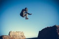 Man performs freerunning jump on stones Royalty Free Stock Photo