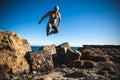 Man performs freerunning jump on stones Royalty Free Stock Photo