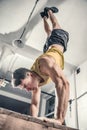 Man performs handstanding at the gym