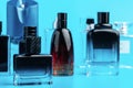 Man perfume bottle on blue background close up Royalty Free Stock Photo