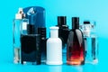 Man perfume bottle on blue background. creative photo. Royalty Free Stock Photo