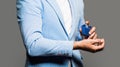 Man perfume, fragrance. Masculine perfume. Man holding up bottle of perfume. Fashion cologne bottle. Man in a suit Royalty Free Stock Photo