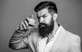 Man perfume, fragrance. Masculine perfume. Male fragrance and perfumery, cosmetics. Bearded man holding up bottle of