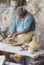 A man in period costume demonstrating the skill of pottery in the Nathereth Village Museum where life in 1st century Israel