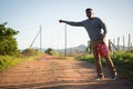 Man with petrol can hitchhiking at countryside Royalty Free Stock Photo