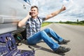 Man with phone is calling in service of spare tire car Royalty Free Stock Photo