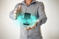 Man with phone floating between his hands and holographic digital icons.