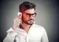 Man on the phone with headache. Upset unhappy guy talking on a cellphone Royalty Free Stock Photo