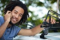 man on phone installing car roof rack outdoors Royalty Free Stock Photo