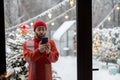 Man with phone near Christmas tree outdoors