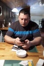 Man with phone in a pub