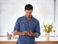 Man, phone and reading communication in kitchen with notification, typing and text message in home. Person, smartphone