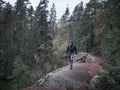 Man with photo camera hiking in the forest in Tiveden National Park in Sweden