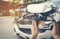 A man photographed his vehicle with accidental damage with a smart phone.Car Insurance Concept Royalty Free Stock Photo