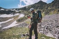 Man photographer with backpack hiking in mountains Travel Lifestyle adventure concept Royalty Free Stock Photo