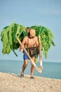 MAN PHOTOGRAPHER ON THE BEACH, MAKES PHOTOS WITH A PET MONKEY