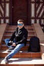 Man photographer black clothes, sunglasses sitting Royalty Free Stock Photo