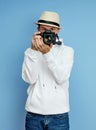 Man photographer with a SLR camera in his hands takes photos Royalty Free Stock Photo