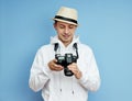 Man photographer with a SLR camera in his hands takes photos Royalty Free Stock Photo