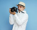 Man photographer with a SLR camera in his hands takes photos Royalty Free Stock Photo