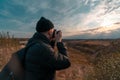 Man photographer taking photo of sunset and mountains. Travel Lifestyle. active hobby. vacation hiking climbing Royalty Free Stock Photo