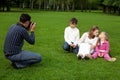 Man photographes his family outdoors Royalty Free Stock Photo