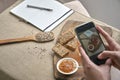 Man photographing breakfast with smart phone before eat. personal perspective point of view