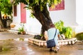Man photographing plants in Louangphabang, Laos. Copy space for