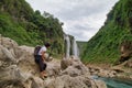 man photographing River and amazing crystalline blue water of Tamul waterfall in San Luis PotosÃÆÃÂ­, Mexico