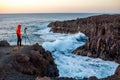 Man photographing rocky coast on Lanzarote island