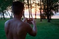 Man photographing sunset with mobile phone