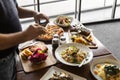 Man Photographing Tasty Italian Dishes on Restaurant Table Royalty Free Stock Photo