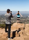 Man photographing woman hiker