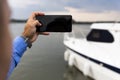 Man photographing with smartphone at the river Royalty Free Stock Photo