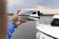 Man photographing Yacht with smartphone at the river Royalty Free Stock Photo