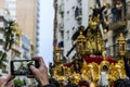 A man photographs with his mobile phone the Procession of Jesus the Nazarene in Huelva, Spain