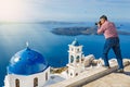 Man photographs island of Santorin Royalty Free Stock Photo