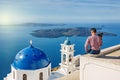 Man photographs island of Santorin Royalty Free Stock Photo