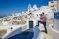 Man photographs  island of Santorini Royalty Free Stock Photo