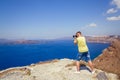 Man photographs the landscape of Santorini Royalty Free Stock Photo