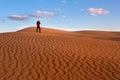 A man photographs the sand dunes of the desert. Photographer in the desert Royalty Free Stock Photo