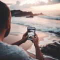 Man photographs a stormy sea on a smartphone, large waves, close-up,