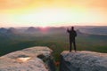 Man photography on peak of rock empire. Dreamy spring landscape Royalty Free Stock Photo