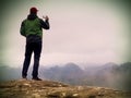 Man photography by phone. Trip in mountains, sharp rock empire Royalty Free Stock Photo