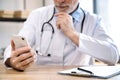 man physician searching patient medical records in smartphone Royalty Free Stock Photo