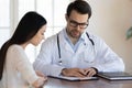 Male doctor explain prescription to female patient at consultation Royalty Free Stock Photo