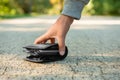 Man picking lost wallet from ground outdoors, closeup. Space for text Royalty Free Stock Photo