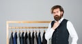 Man picking suit from personal wardrobe, fashion clothes concept