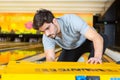 man picking up bowling ball from rack in club Royalty Free Stock Photo