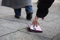 Man Picking Up A Lost Purse